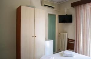 a bedroom with a white cabinet and a television at Egnatia Hotel in Ioannina