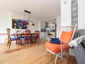 a kitchen and dining room with a table and chairs at Rock Pool House in Helston
