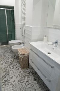 a white bathroom with a toilet and a sink at La Candida Rosa in Florence