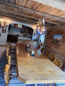 a dining room with a large wooden table and chairs at Stilvolle grosszügige 7.5 Zi Maisonette Wohnung 10 Pers in Saas-Fee +40 photos