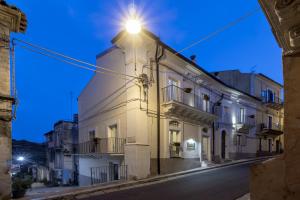 a building with a light on the top of it at Via Barocca in Ragusa