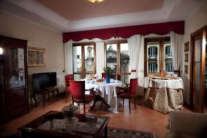 a living room with a table and chairs and a room with at Napoli Porta Di Mare in Naples
