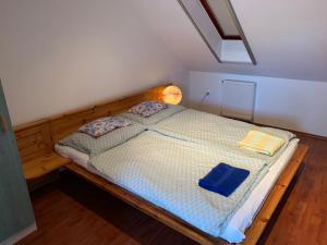 a bedroom with a bed with two books on it at Solar Apartman in Vonyarcvashegy