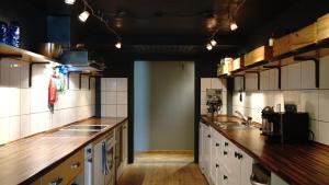 a large kitchen with wooden counter tops and cabinets at Basecamp Andermatt in Andermatt