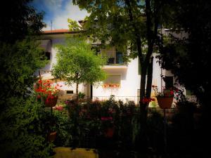 a white house with flowers in front of it at Bed & Breakfast Don Carlos in San Martino di Lupari