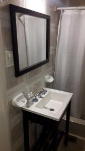 a bathroom with a white sink and a mirror at HOTEL KAPAC in Mendoza