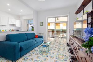 a living room with a blue couch and a table at Estate4Home - Casa Maridea in Sorrento