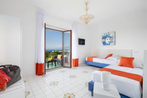 a bedroom with two beds and a balcony at Estate4Home - Casa Maridea in Sorrento +31 photos