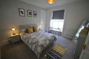 a bedroom with a bed and a window at Heritage Holiday Accommodation in Pembrokeshire +8 photos