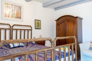 a bedroom with two beds and a cabinet at casa n'donda in Cuccaro Vetere