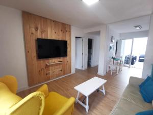 a living room with a tv and a couch and a table at Casa La Cañada in La Orotava