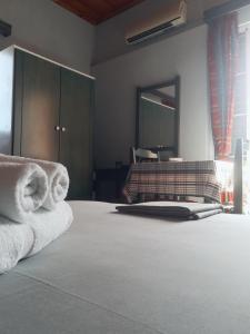 a bedroom with a bed with towels on it at CAPTAIN GEORGE in Sougia