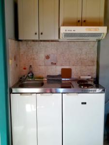a kitchen with a sink and a counter top at CAPTAIN GEORGE in Sougia +9 photos