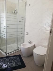 a bathroom with a shower and a toilet and a sink at Cristel Malpensa apartment in Cardano al Campo
