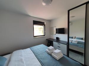 Postel nebo postele na pokoji v ubytování Apartmani Nerium