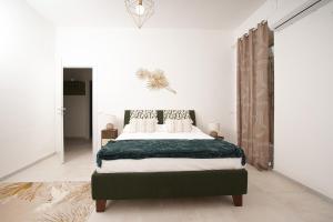 Łóżko lub łóżka w pokoju w obiekcie Ortigia Boutique Plaza Apt