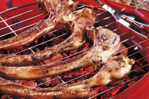 a bunch of sausages cooking on a grill at Maverick Camp, Rondavels and Homestay in Nyandarua 