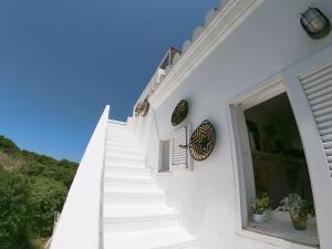 a white staircase leading up to a white building at Castell Sol - Arenal Den Castell in Arenal d'en Castell