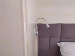 a lamp sitting on the corner of a bed at Dony's holiday homes CISE 14923 
