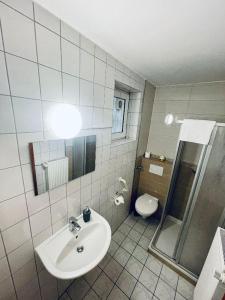 a bathroom with a sink and a toilet at Hotel Sankt Lorenz in Lübeck