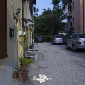 a street with cars parked on the side of a building at Casa di Irene in Reggio Emilia