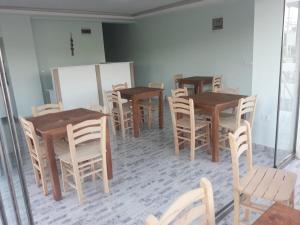 a dining room with wooden tables and chairs at Geyikli Paris Otel in Canakkale +41 photos