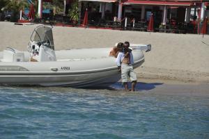 a man and a small child on a boat in the water at La Solenzara Hôtel in Sari Solenzara