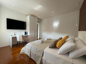a bedroom with a large bed with a television on the wall at Nature Room in Olbia