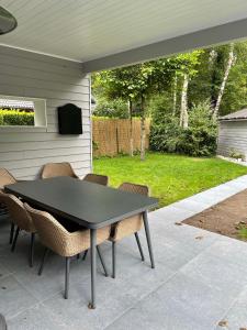 a black table and chairs on a patio at Time To in Aalter