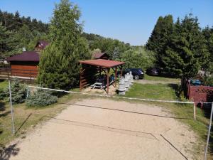 a playground with a gazebo and a cabin at Domki Anastazewo in Anastazewo