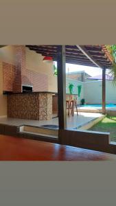 a kitchen and dining area of a house with a patio at Casa de Praia Alter do Chão in Alter do Chao