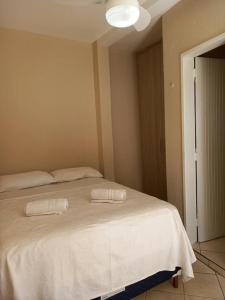 En eller flere senge i et værelse på Hospedagem em Diamantina