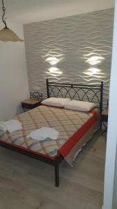 a bed with two pillows on it in a room at Germanos Studios in Mýkonos City