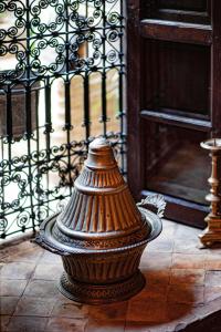 a vase sitting on top of a wooden table at Riad Zhor in Marrakesh