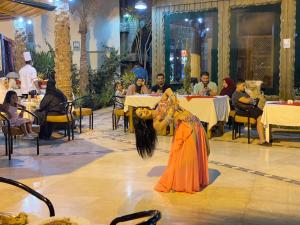 a woman sitting at a table in a restaurant at Naama Inn Hotel in Sharm El Sheikh