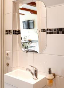 a bathroom with a sink and a mirror at Sunflower Amsterdam in Amsterdam +35 photos