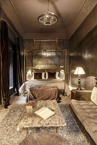 a bedroom with a bed with a table and a couch at Riad Zhor in Marrakesh