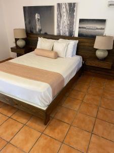 
a bedroom with a bed and a dresser at El Morro Eco Adventure Hotel in San Fernando de Monte Cristi
