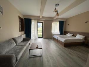A bed or beds in a room at Hotel Axien Kazbegi