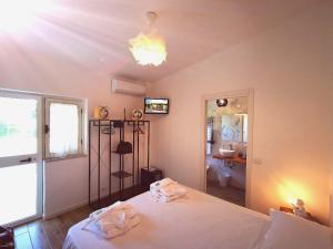 a bedroom with a bed and a bathroom with a sink at Il Giardino dei Pini in Paestum