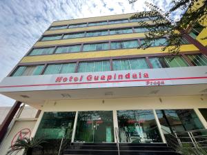 a building with a sign on the front of it at Hotel Guapindaia Praça in Rio Branco