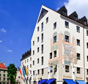 a building with a large mural on the side of it at Platzl Hotel - Superior in Munich