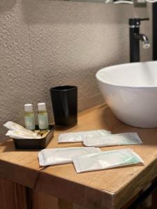 a bathroom counter with a sink and two bottles of soap at Petra Holiday Home in Pietrapertosa