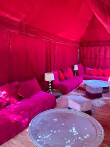 une chambre rouge avec des canapés et une table dans l'établissement The Bohemian Jungle, à Marrakech