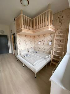 1 dormitorio con cama blanca y altillo en Apartmán Slapy-Ždáň en Slapy