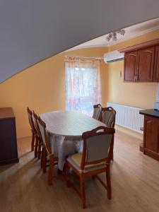 a dining room with a table and chairs at Julius Apartman in Hajdúszoboszló