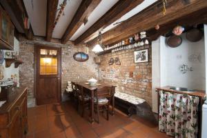 a kitchen with a table and a brick wall at Ca' Rielo in Venice