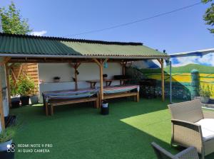 a gazebo with a bench and a picnic table at Chambres d'hôtes - Domaine Beau Sejour in Biaudos