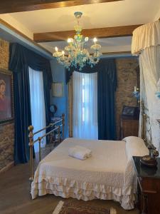 a bedroom with a bed and a chandelier at Principe Di Scilla in Scilla