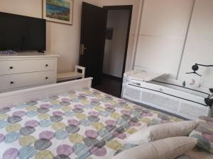 a bedroom with a bed and a dresser and a television at SUNSHINE CRIKVENICA in Crikvenica